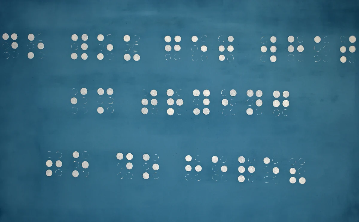 Blue surface with white painted Braille-like dots