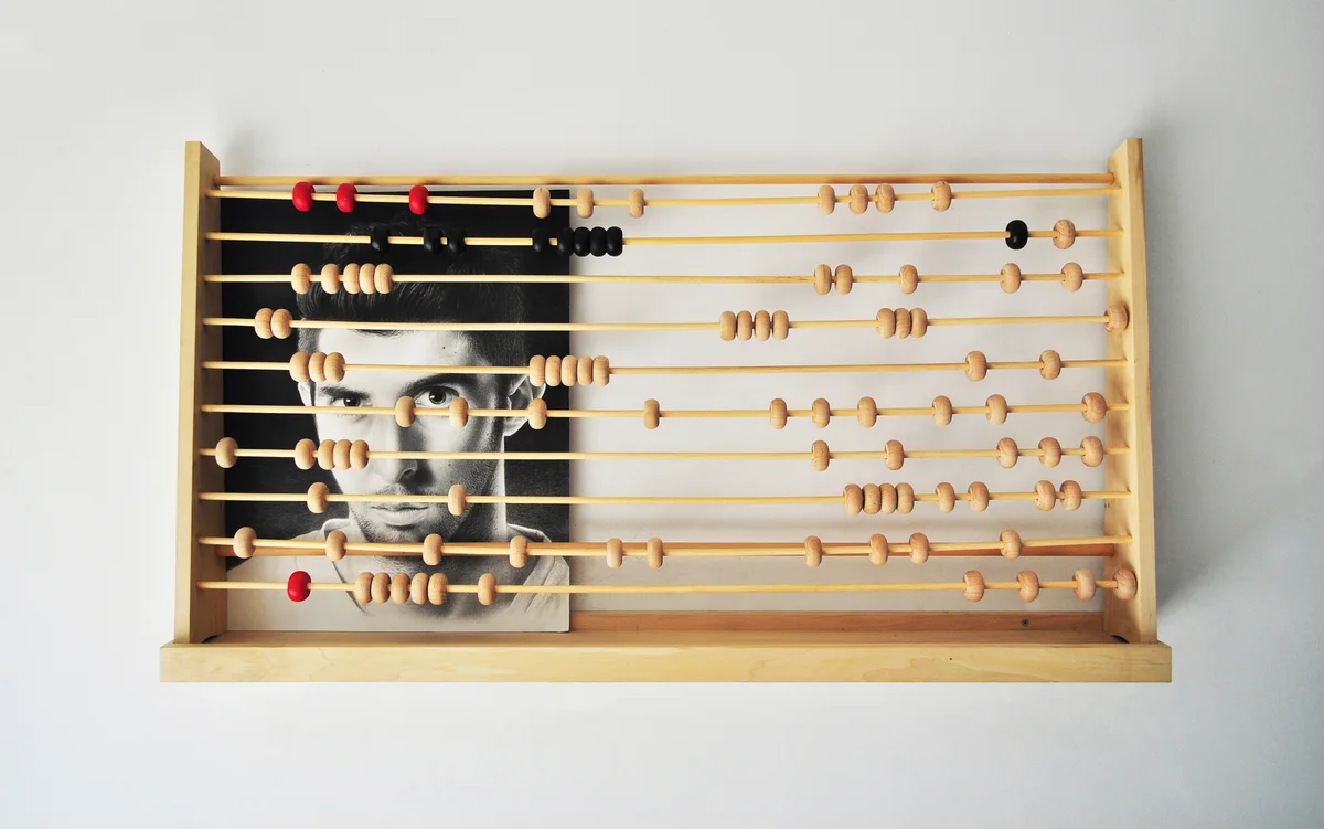 Prisoners, an oversized abacus-like sculptural work containing a portrait